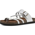 A white leather slide sandal with braided straps, a silver-tone buckle, and a brown cork-look footbed on a black outsole, shown against a plain white background.