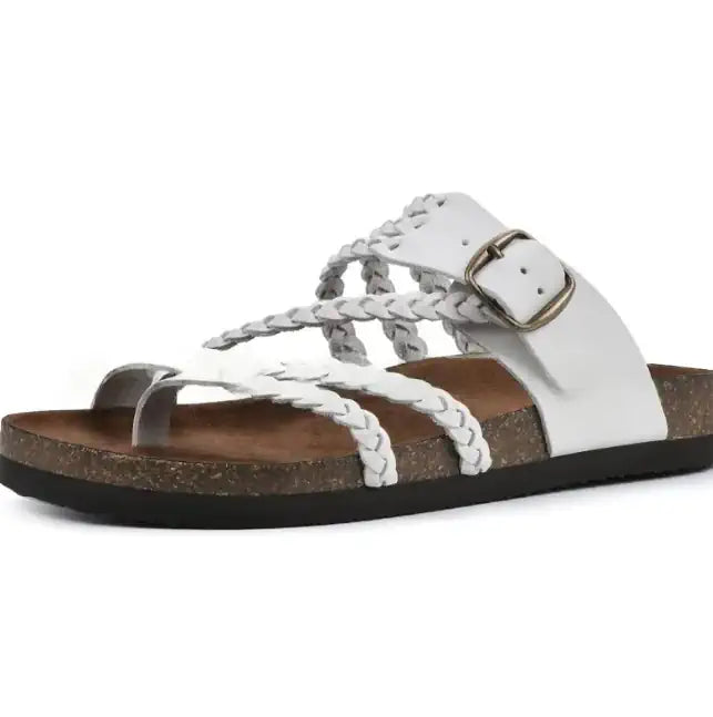 A white leather slide sandal with braided straps, a silver-tone buckle, and a brown cork-look footbed on a black outsole, shown against a plain white background.