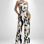 ZOFIA ATELIER white and black abstract print halter neck sleeveless wide-leg jumpsuit with elastic waist.