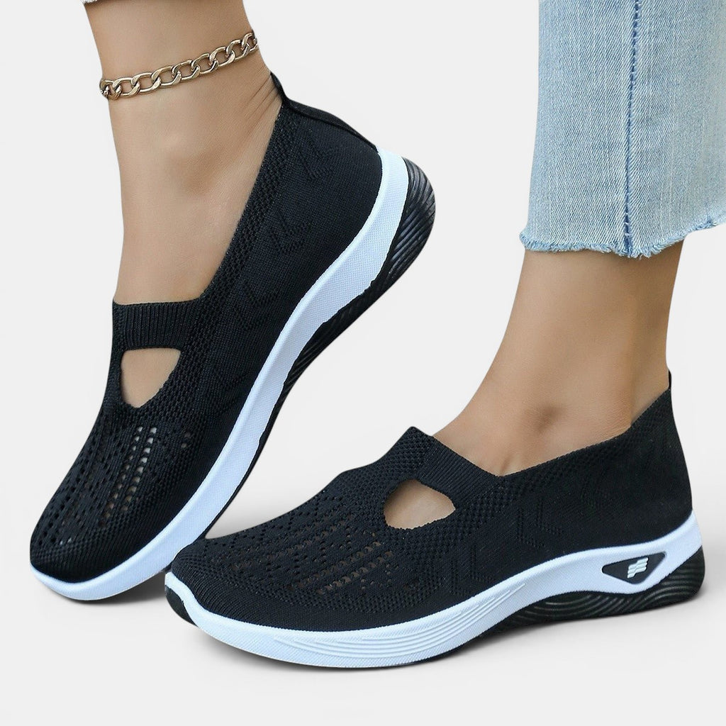 ZOFIA ATELIER AGATA black knit slip-on sneakers with white soles and a cutout detail.