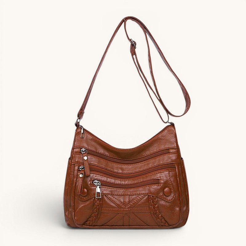 ZOFIA ATELIER AGNIESZKA brown PU leather messenger bag with multiple zippered pockets and braided detail.