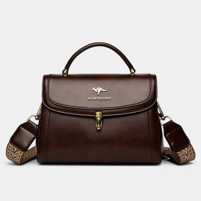 ZOFIA ATELIER Agnieszka brown PU leather crossbody handbag with textured strap and gold kangaroo logo.
