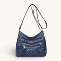 ZOFIA ATELIER AGNIESZKA navy blue PU leather messenger bag with multiple zippered pockets and braided detail.