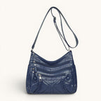 ZOFIA ATELIER AGNIESZKA navy blue PU leather messenger bag with multiple zippered pockets and braided detail.