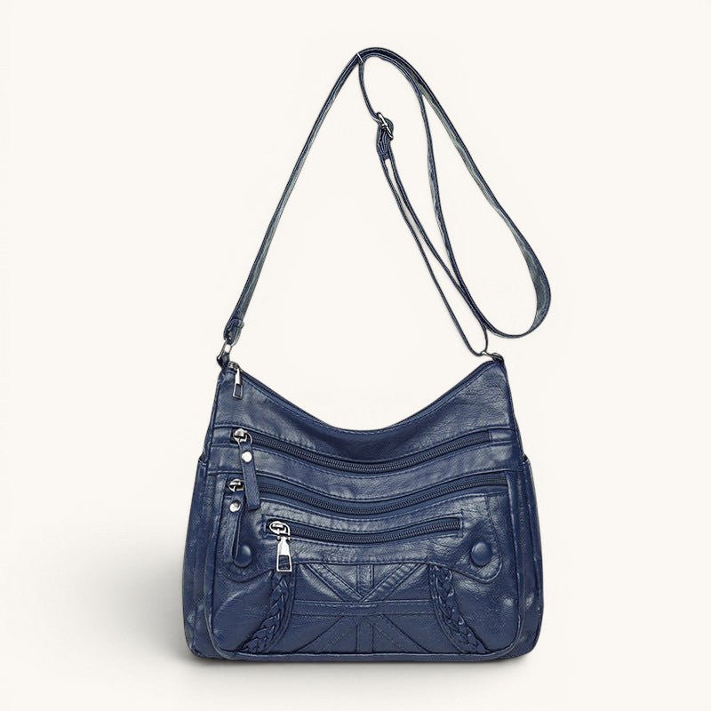 ZOFIA ATELIER AGNIESZKA navy blue PU leather messenger bag with multiple zippered pockets and braided detail.