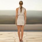 ZOFIA ATELIER ALEKSANDRA short satin halter neck dress with waist tie detail in a light beige color.