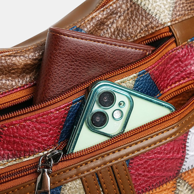ZOFIA ATELIER ANIA multi-layer crossbody bag in brown PU with patchwork design, holding a phone and wallet.