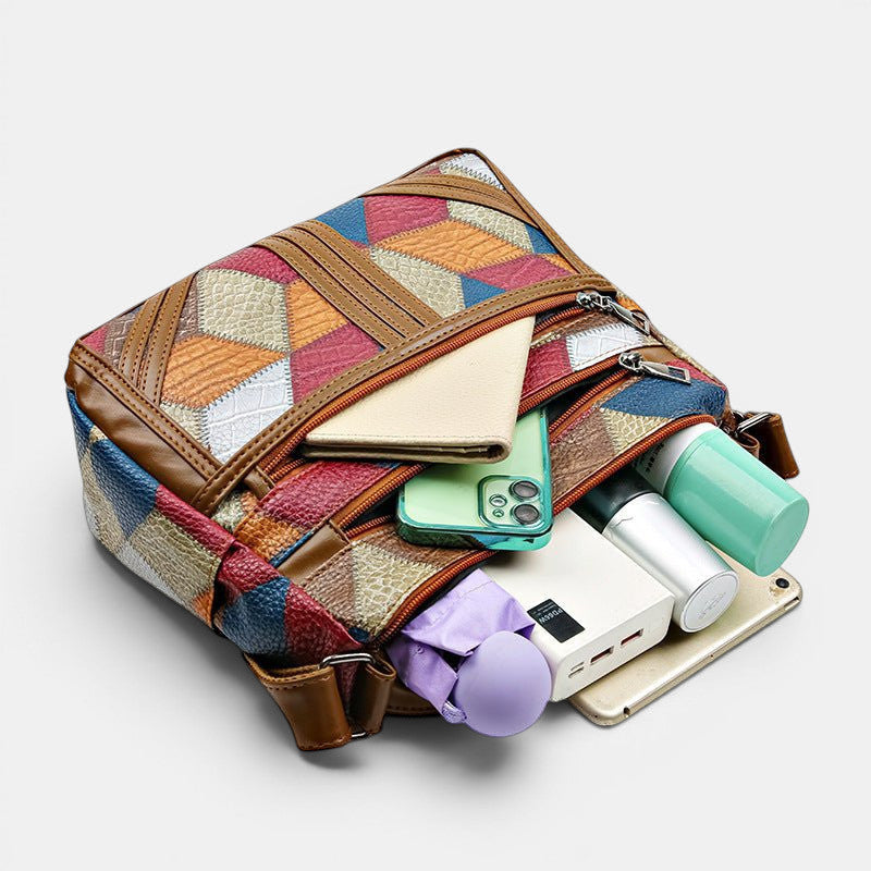 ZOFIA ATELIER ANIA multi-layer crossbody bag in patchwork leather with brown trim. Features multiple compartments and a single shoulder strap.