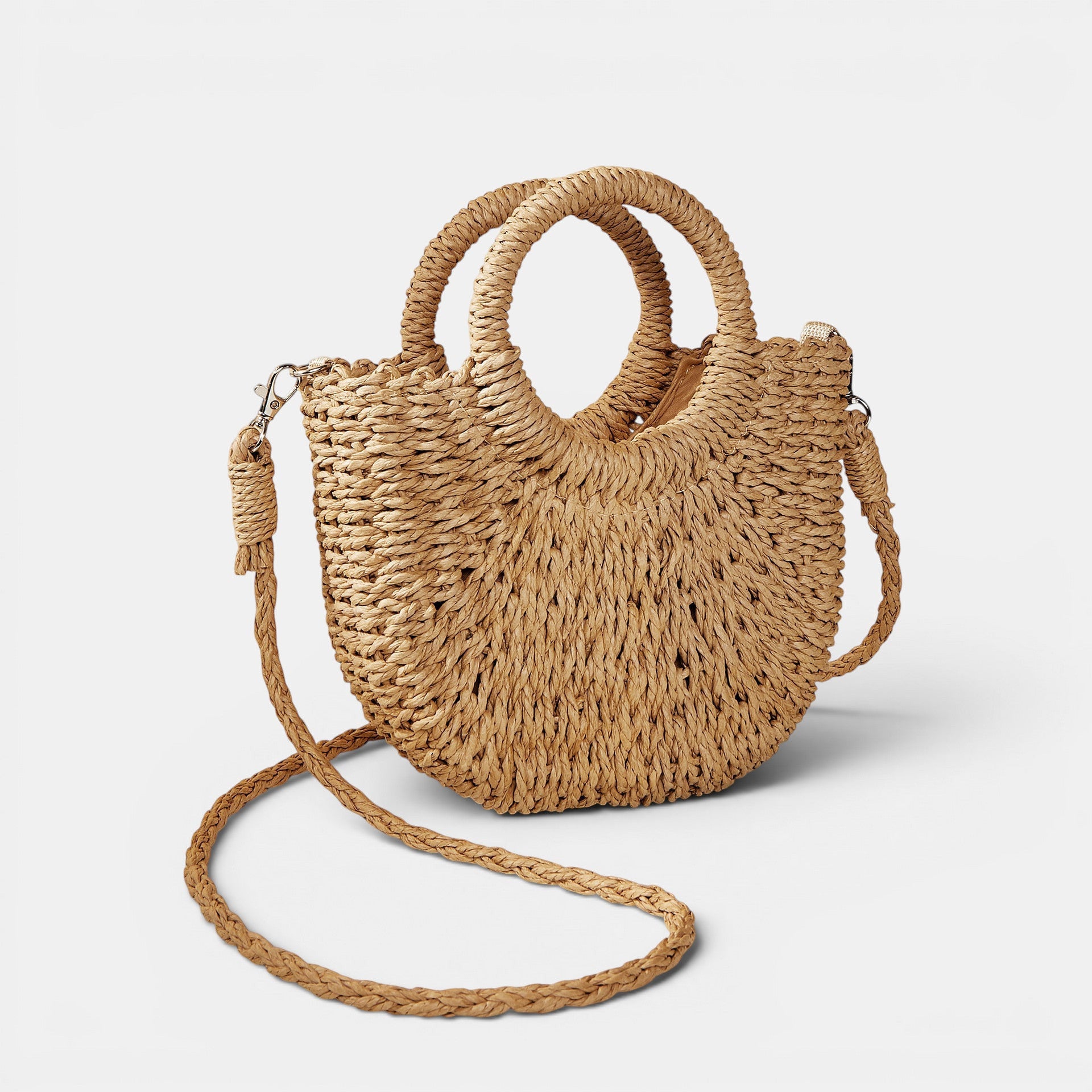 ZOFIA ATELIER Anna crossbody bag made of woven paper in a natural tan color with rounded handles and a long braided strap.