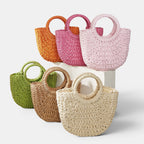 ZOFIA ATELIER Anna beach crossbody bag in woven paper with round handles, available in multiple colors.