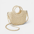 ZOFIA ATELIER ANNA crossbody bag made of woven paper in a natural beige color with round top handles and a long braided strap.