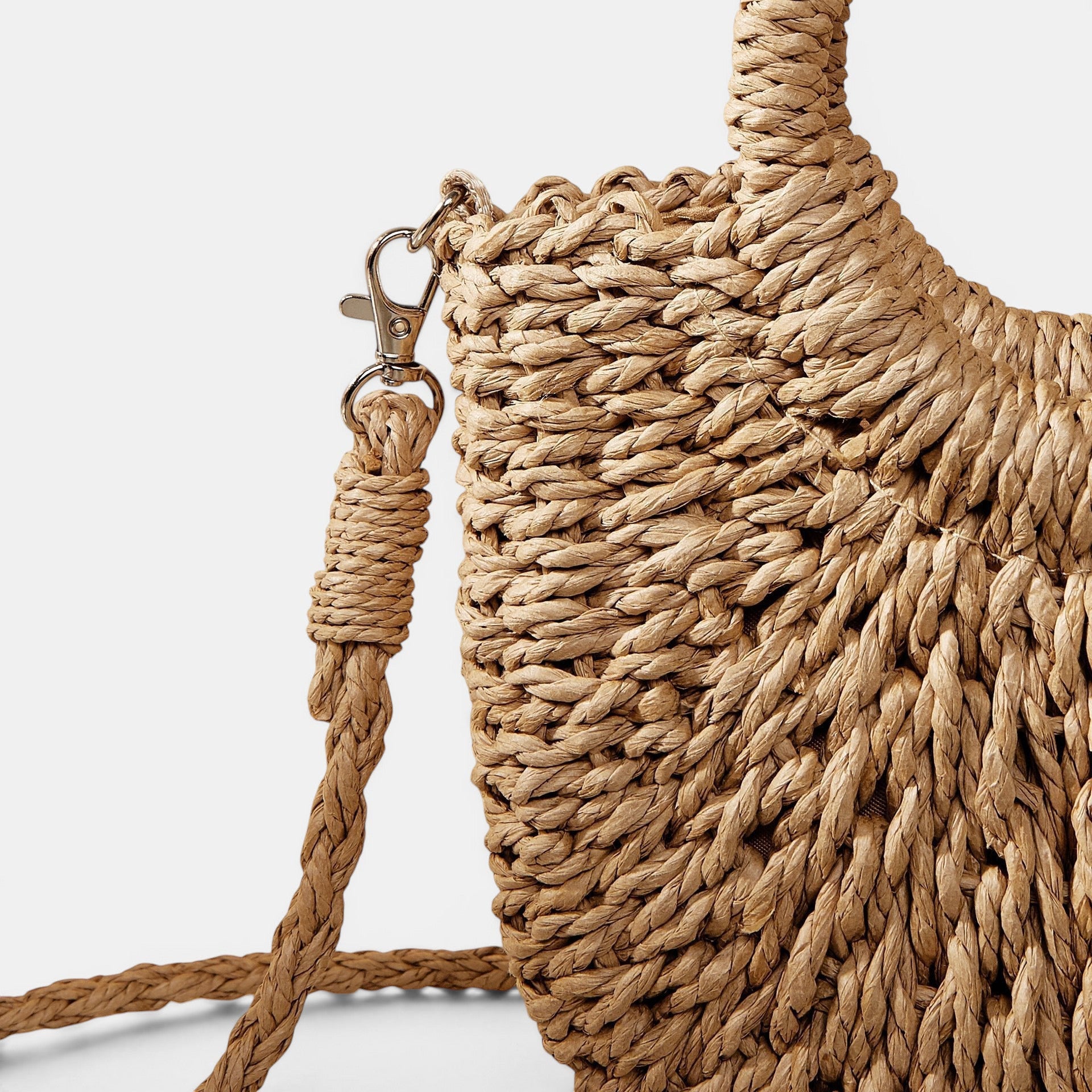 ZOFIA ATELIER ANNA crossbody bag made of woven paper in a natural camel color with a peach skin lining and braided strap.