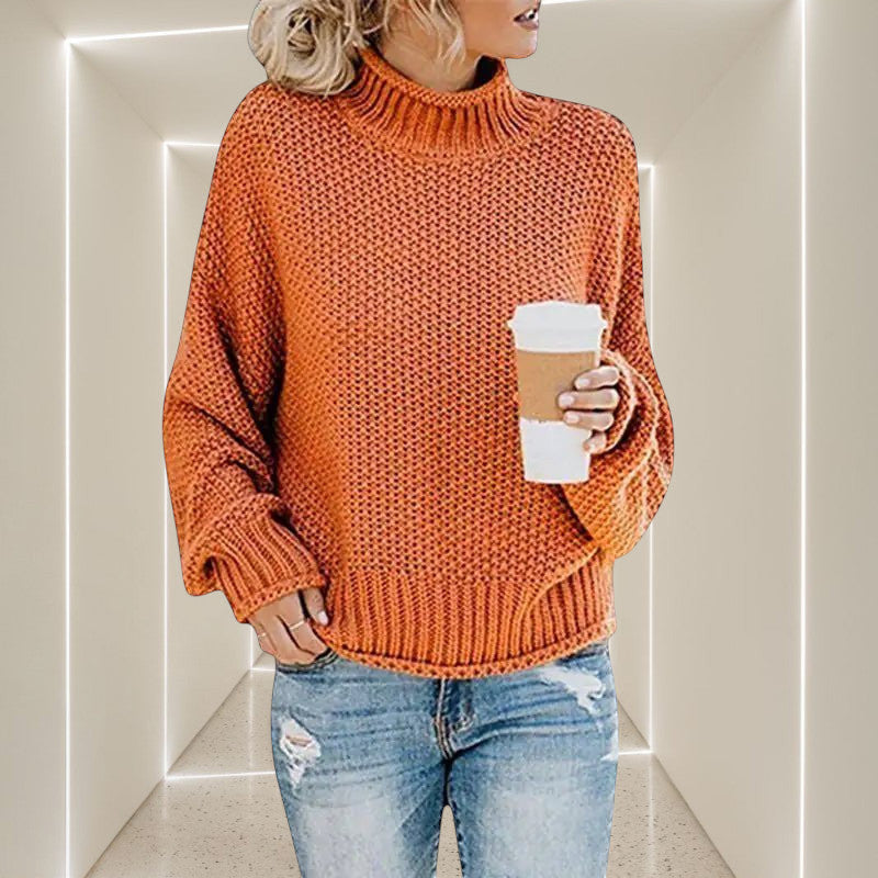 ZOFIA ATELIER ANNA orange chunky knit turtleneck sweater with relaxed fit and bell sleeves.