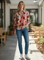 ZOFIA ATELIER BEATA long sleeve blouse with a vibrant floral print in red, orange, and blue on a cream background.