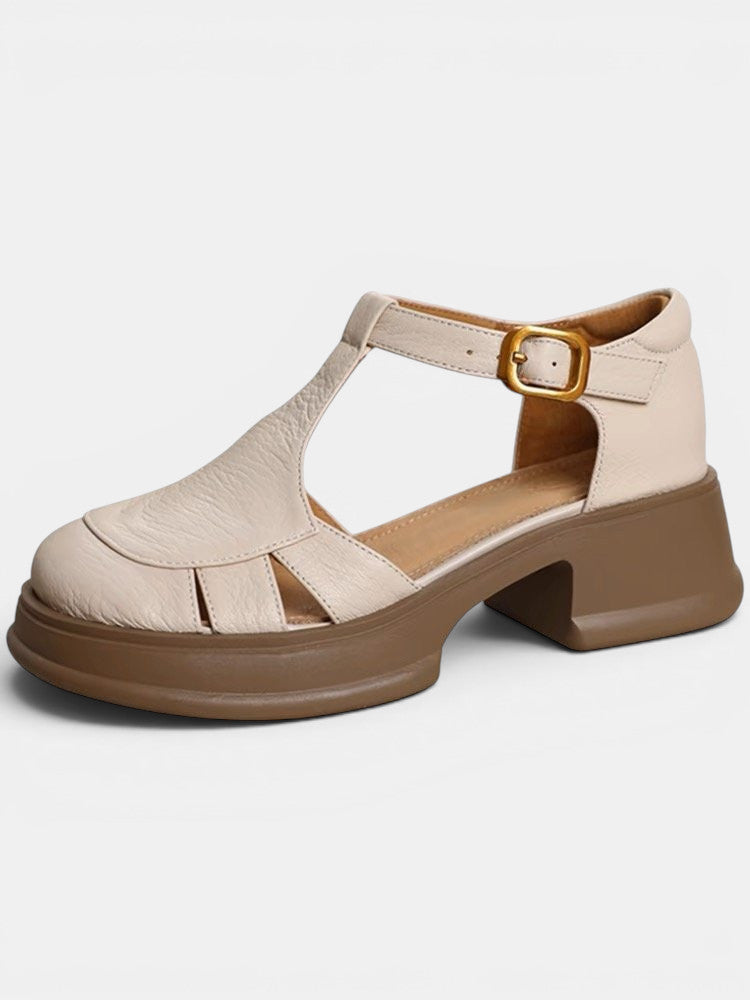 ZOFIA ATELIER beige PU leather t-strap chunky heel sandals with buckle closure and round toe.