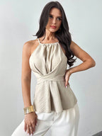 ZOFIA ATELIER beige halter neck sleeveless blouse with wrap waist and open back detail. Polyester.