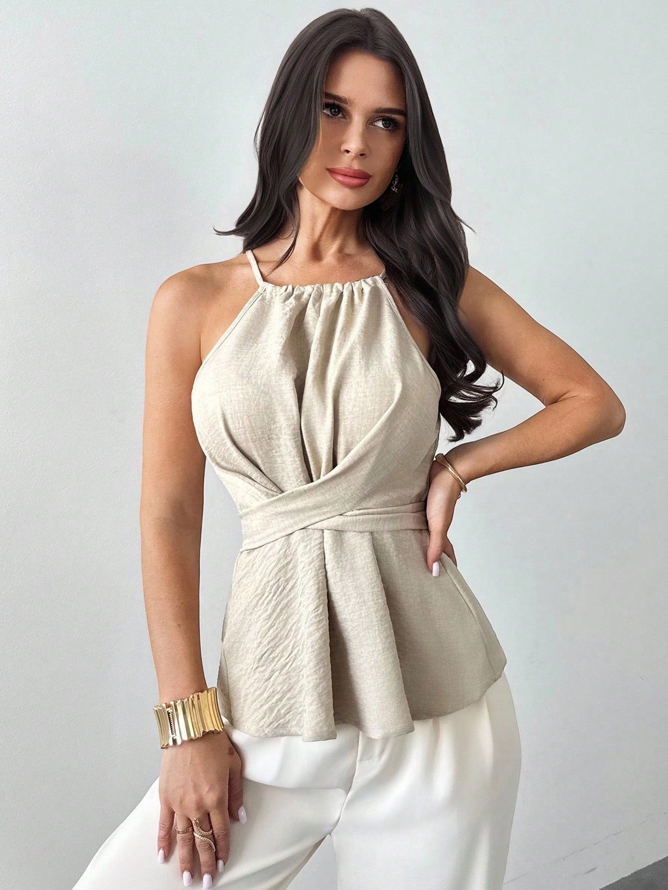 ZOFIA ATELIER beige halter neck sleeveless blouse with wrap waist and open back detail. Polyester.