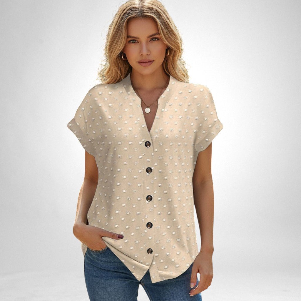 ZOFIA ATELIER beige jacquard V-neck blouse with short sleeves and button front, worn by a woman.