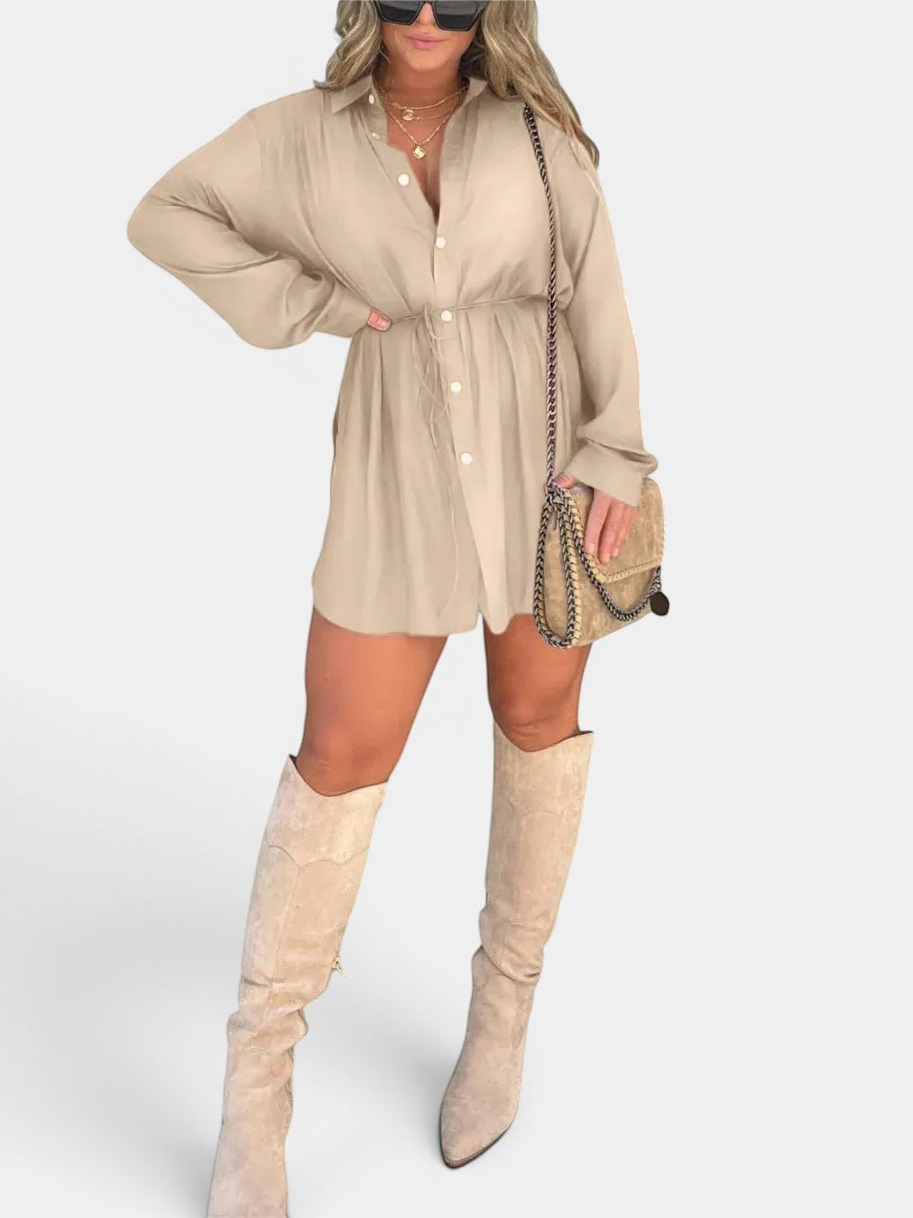 ZOFIA ATELIER beige long sleeve button front shirt dress with lace-up waist detail and short skirt. Model wears knee-high boots and a crossbody bag.