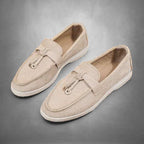ZOFIA ATELIER beige suede loafers with tassel detail and flat sole. Comfortable slip-on style for everyday wear.