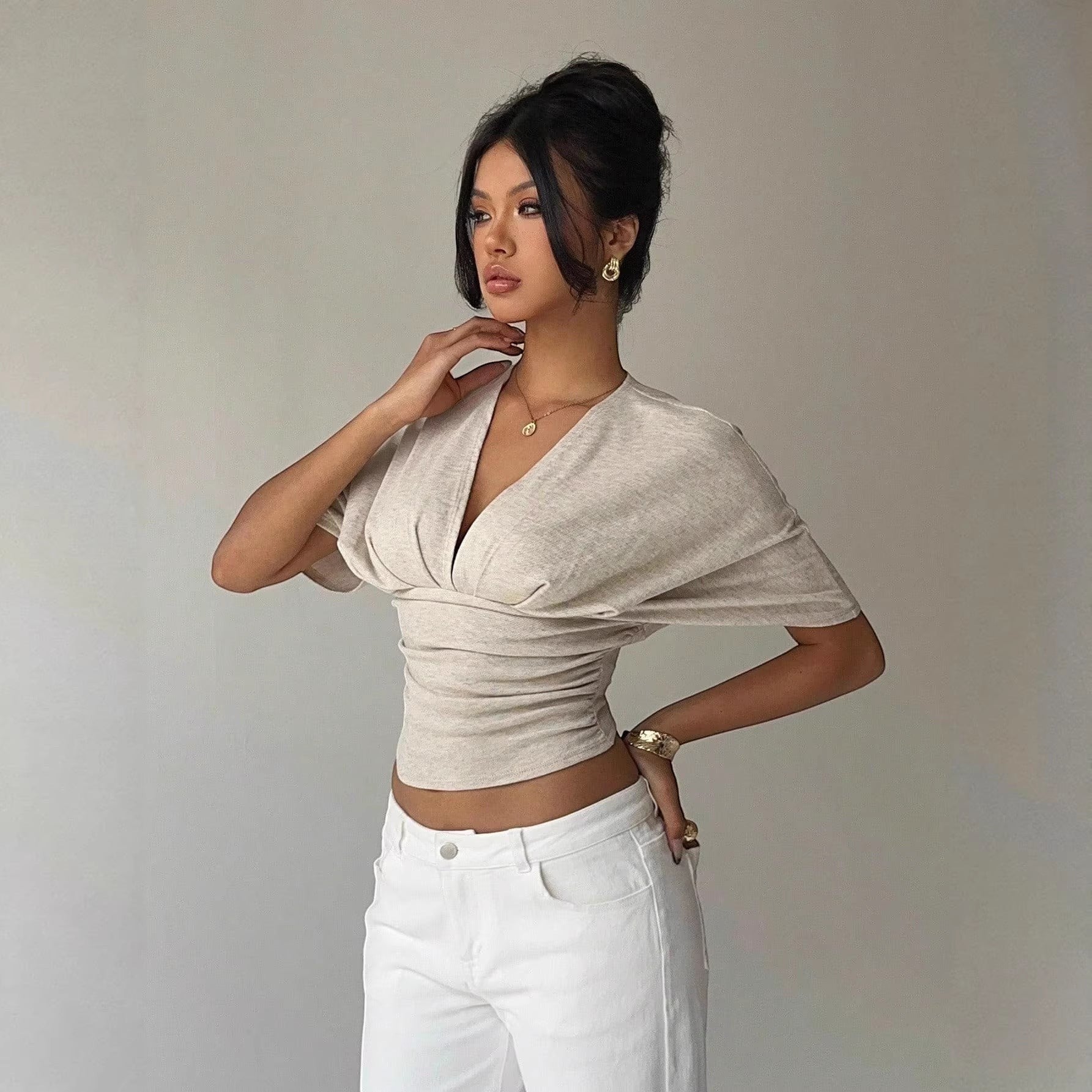 ZOFIA ATELIER light beige polyester slim fit deep V-neck short-sleeve t-shirt with ruched detailing.