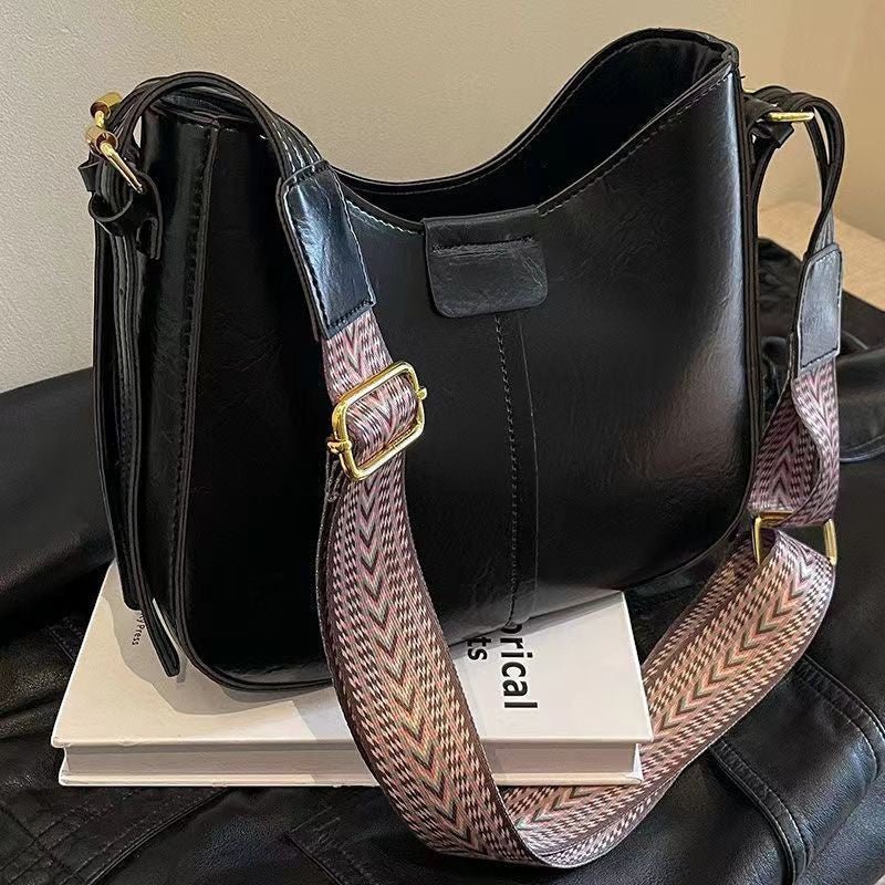 ZOFIA ATELIER black faux leather crossbody bag with patterned strap and gold hardware. Retro style.