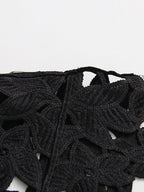 ZOFIA ATELIER black floral lace crop top with round neckline and short sleeves, featuring an openwork design.