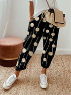 ZOFIA ATELIER black cropped pants with gold polka dots and white stripes, loose fit, cotton-linen blend.