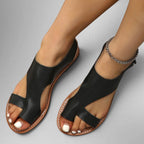 ZOFIA ATELIER black leather flat sandals with velcro toe strap and round toe. Features a silver ankle chain.