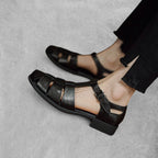 ZOFIA ATELIER black genuine leather retro Roman sandals with buckle strap and chunky sole.