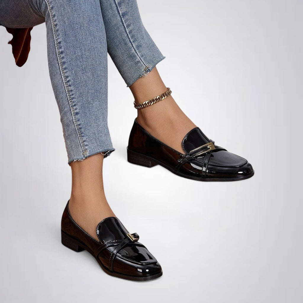 ZOFIA ATELIER black patent leather square toe loafers with gold buckle detail and flat sole.
