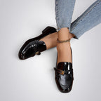 ZOFIA ATELIER black patent leather square toe loafers with buckle detail. Flat sole, slip-on style.