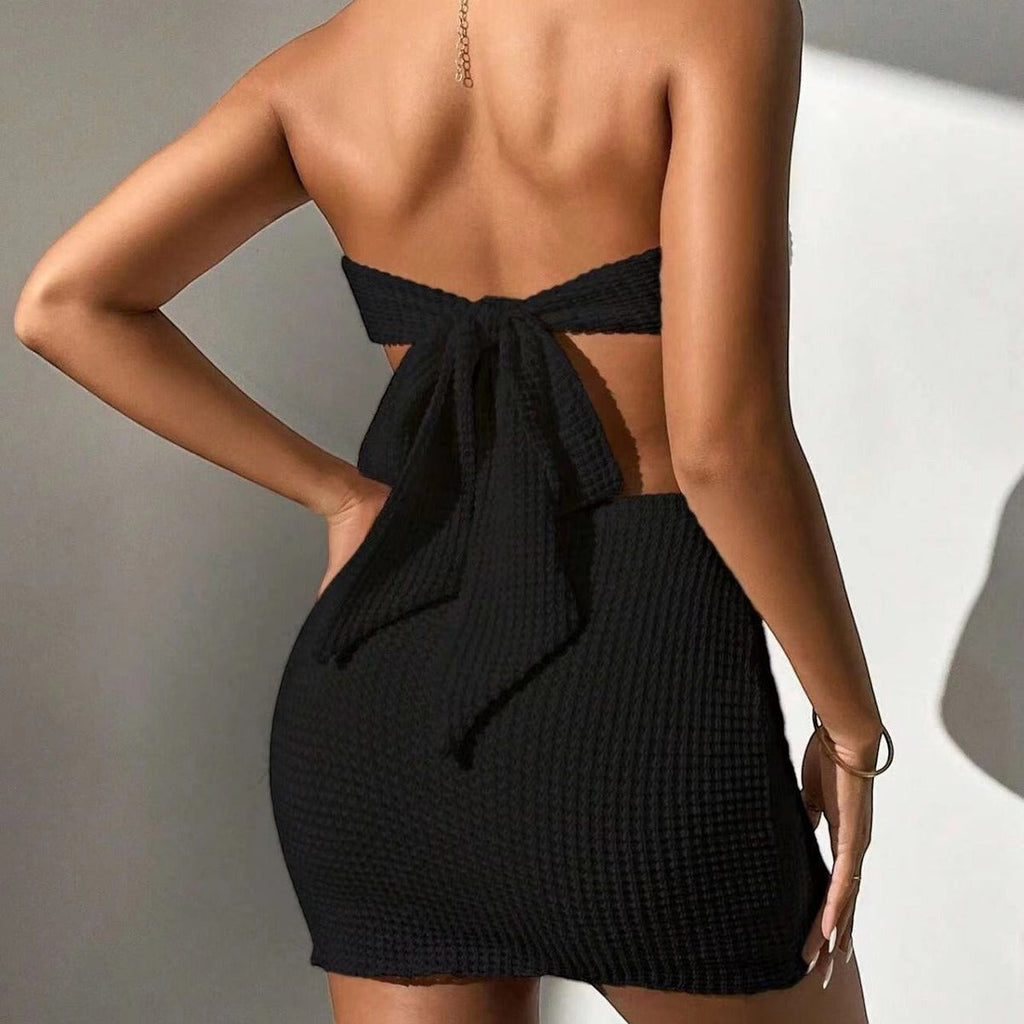 ZOFIA ATELIER black polyester two-piece suit dress with a lace skirt and bow tie back detail.