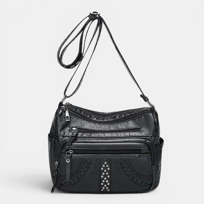ZOFIA ATELIER GRAŻYNA multi-layer crossbody bag in black PU leather with braided detail and silver studs.