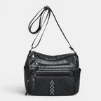 ZOFIA ATELIER GRAŻYNA multi-layer crossbody bag in black PU leather with braided detail and silver studs.