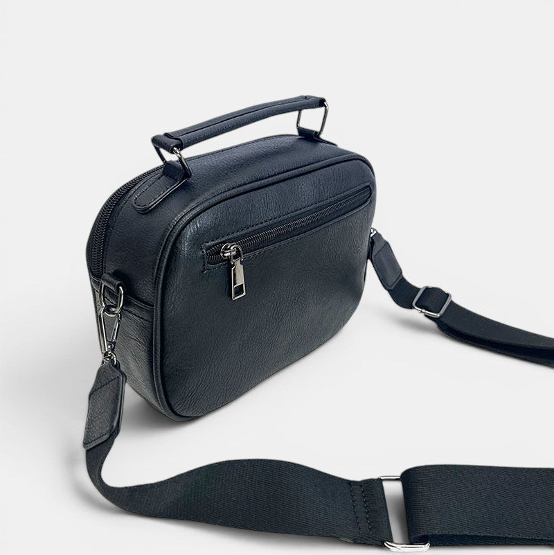 ZOFIA ATELIER black PU leather handbag with top handle and adjustable crossbody strap, featuring a zippered pocket.