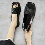 ZOFIA ATELIER black PU square toe casual sandals with elastic slingback strap and rubber sole.