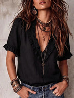ZOFIA ATELIER black polyester V-neck ruffled short sleeve shirt worn by a model.