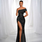 ZOFIA ATELIER black satin off-the-shoulder dress with a high slit and draped detailing.