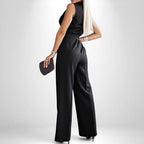 ZOFIA ATELIER black polyester sleeveless wide-leg jumpsuit with lapel collar, belt, and pockets.