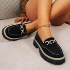 ZOFIA ATELIER black suede chunky platform loafers with gold chain detail and white stitching.