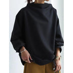 ZOFIA ATELIER BASIA loose black polyester sweater with mock neck and long sleeves, styled casually.