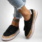 ZOFIA ATELIER black artificial PU tassel round toe flats with cork-effect sole and perforated details.