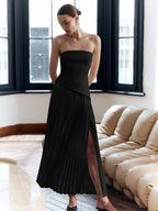 ZOFIA ATELIER black polyester off-the-shoulder tube dress with pleated skirt and thigh-high slit.