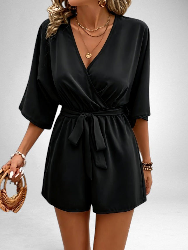 ZOFIA ATELIER black V-neck polyester short jumpsuit with tie waist and regular sleeves.