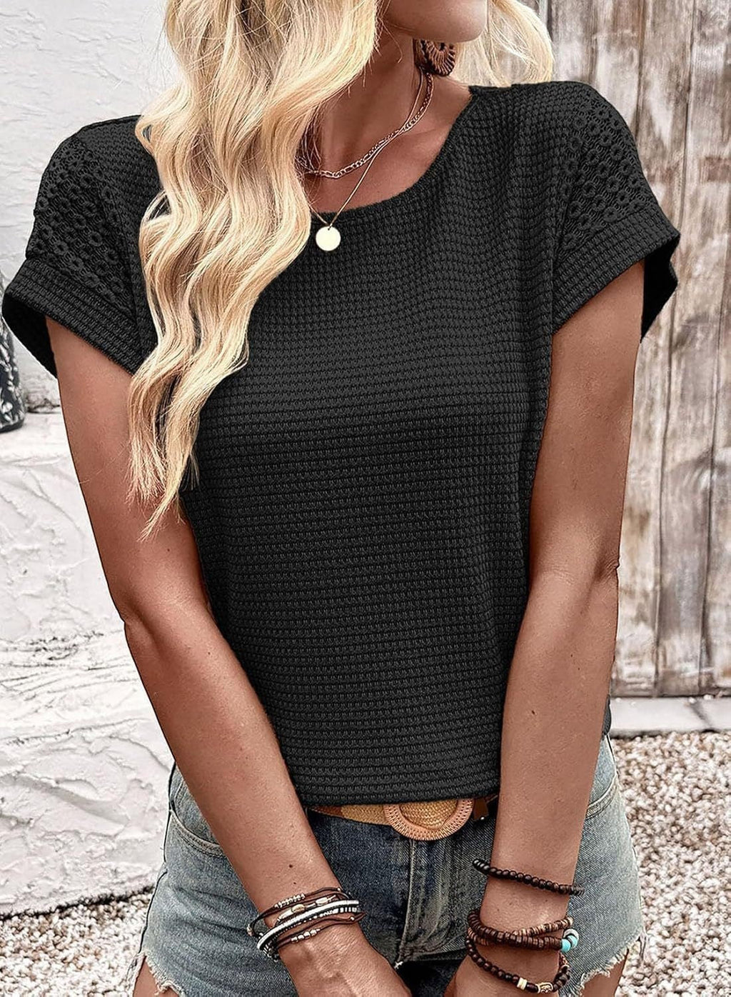 ZOFIA ATELIER Isa black crew neck short sleeve waffle knit blouse with textured sleeves.
