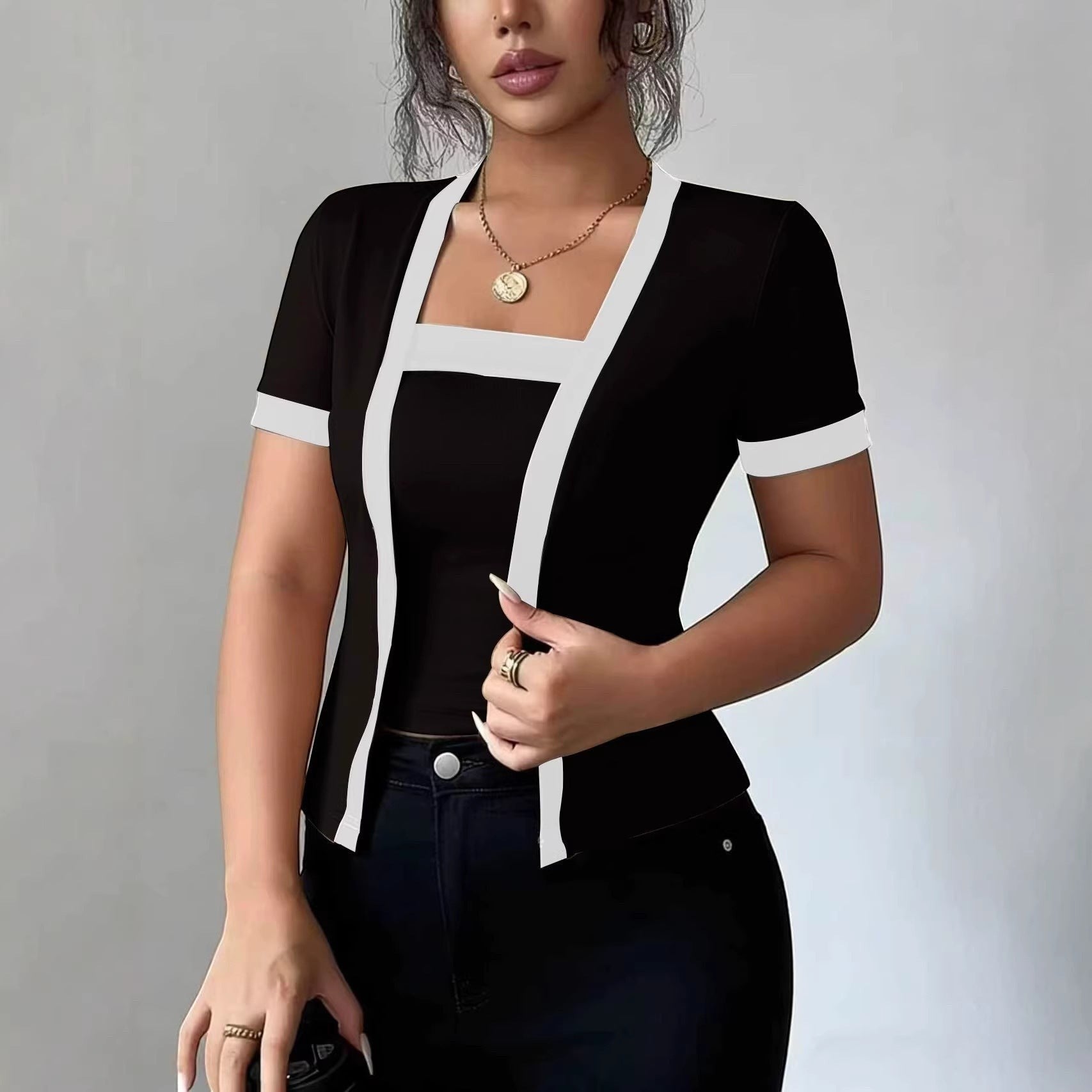ZOFIA ATELIER black faux two-piece cardigan with white trim and square neckline, made of spandex.
