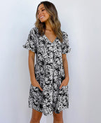 ZOFIA ATELIER black and white floral print mini dress with V-neck, short sleeves, and pockets.