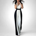 ZOFIA ATELIER black and white pleated wide-leg jumpsuit with V-neckline and sleeveless design.