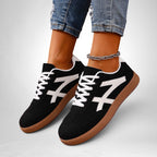 ZOFIA ATELIER black and white color-block sneakers with a gum sole, lace-up closure, and mesh inner lining.